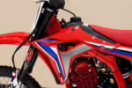 Red dirt bike with blue and white graphics