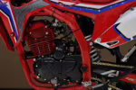 Red dirt bike engine and frame close-up view