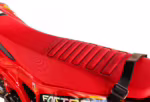 Red motorcycle seat with textured grip pattern