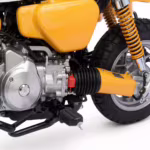 Yellow motorcycle engine and rear wheel close-up
