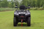 Front view of black YKFB ATV with winch on grass