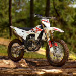 YKF Moto dirt bike on muddy forest trail