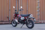 Red mini motorcycle with black seat and off-road tires