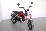 Red Dax mini motorcycle with chrome exhaust