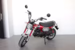 Red Dax style mini motorcycle side view