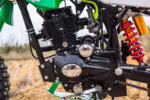 Motor de motocicleta negro con detalles cromados y muelle de suspensión rojo