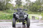 Black ATV quad bike front view on wooden deck