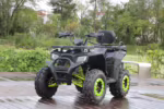 Black ATV with neon green rims parked outdoors