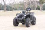 Black electric ATV with rugged tires parked outdoors