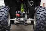 ATV rear suspension with green coil spring and axle