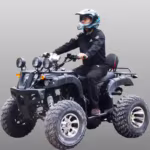 Rider on black ATV with multiple headlights