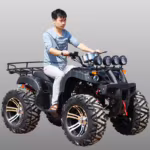Man riding black ATV with four front lights