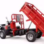 Red four-wheel utility vehicle with hydraulic dump bed