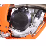Motorcycle engine with black clutch cover and orange frame