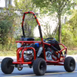 Red off-road go-kart with roll cage parked outdoors