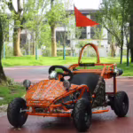 Orange off-road go-kart with spider web pattern