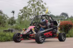 Off-road dune buggy with driver wearing helmet