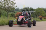 Off-road dune buggy with driver wearing helmet