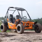 Orange off-road dune buggy with roll cage