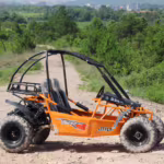 Orange off-road go kart on dirt trail