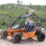Orange off-road dune buggy on rocky trail