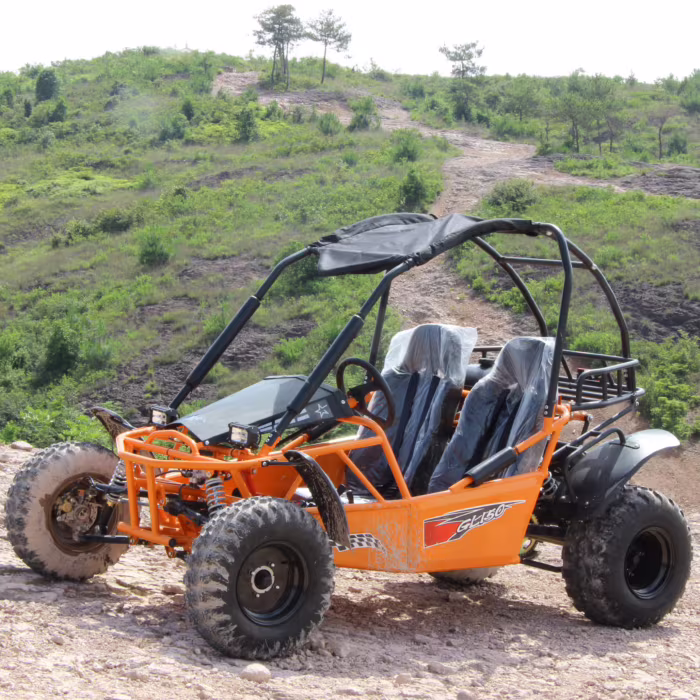 Buggy todoterreno naranja en un sendero rocoso.