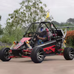 Off-road dune buggy with driver wearing helmet