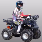 Rider on black ATV quad bike with multiple front lights
