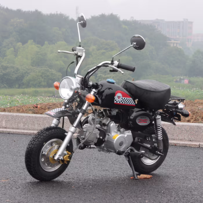 Mini motocicleta preta com decalques quadriculados estacionada ao ar livre