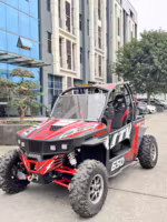 Red and black UTV parked outside modern building