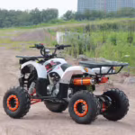 Quadriciclo esportivo branco com rodas laranja em terreno de terra.
