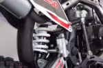 Motorcycle rear suspension shock absorber with white coil spring