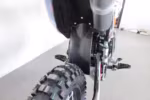 Dirt bike rear wheel with knobby tire and foot pegs