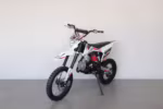 White and red dirt bike on kickstand