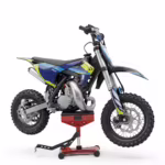 Blue and yellow dirt bike on red stand